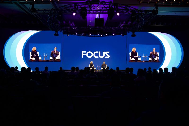 Jenifer Brooks and Ed Elson seated in conversation on the FactSet FOCUS stage in Austin