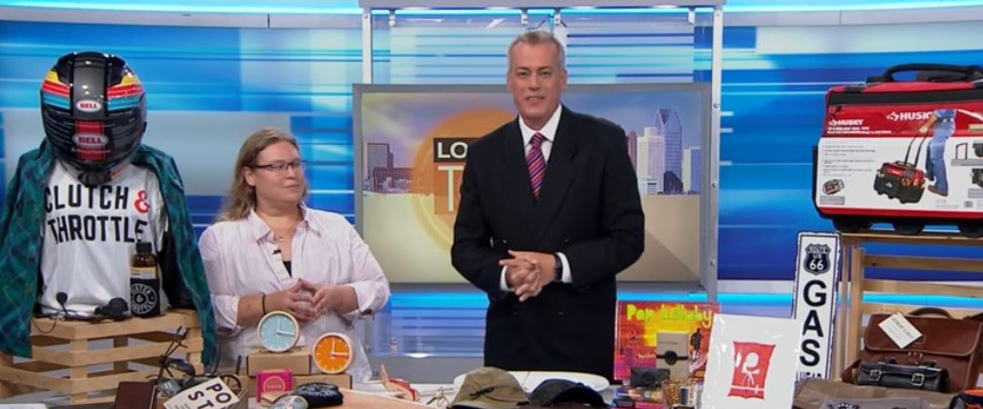 Jennifer Foster in a television studio beside a presenter and a display of retail goods