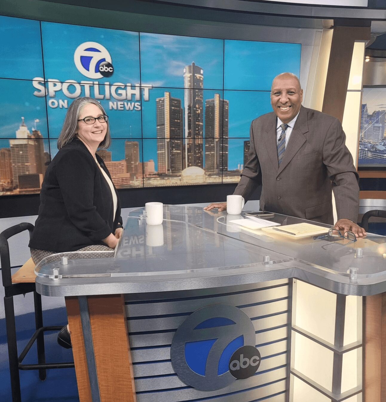 Jennifer Foster standing in the Spotlight on the News television studio with a presenter