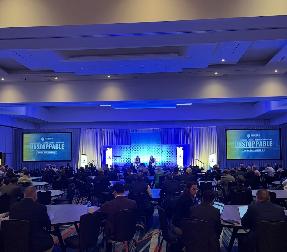 A ballroom audience watches the stage at the eighth annual Steward Partners Symposium in Orlando