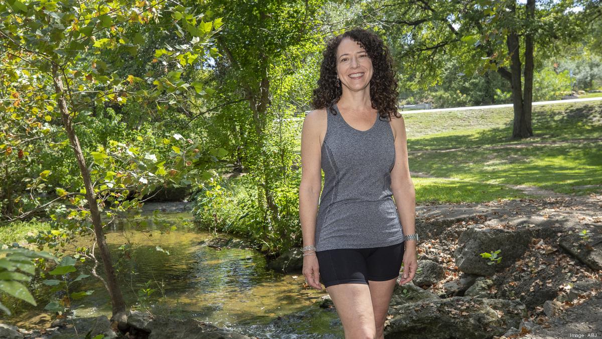 Jennifer Crean standing beside a tree-lined creek