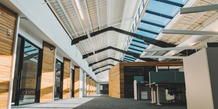 The skylit corridor and open workspaces inside IMC’s office