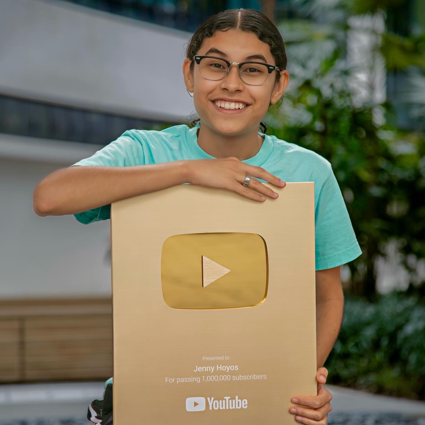Jenny Hoyos holding her YouTube Gold Creator Award