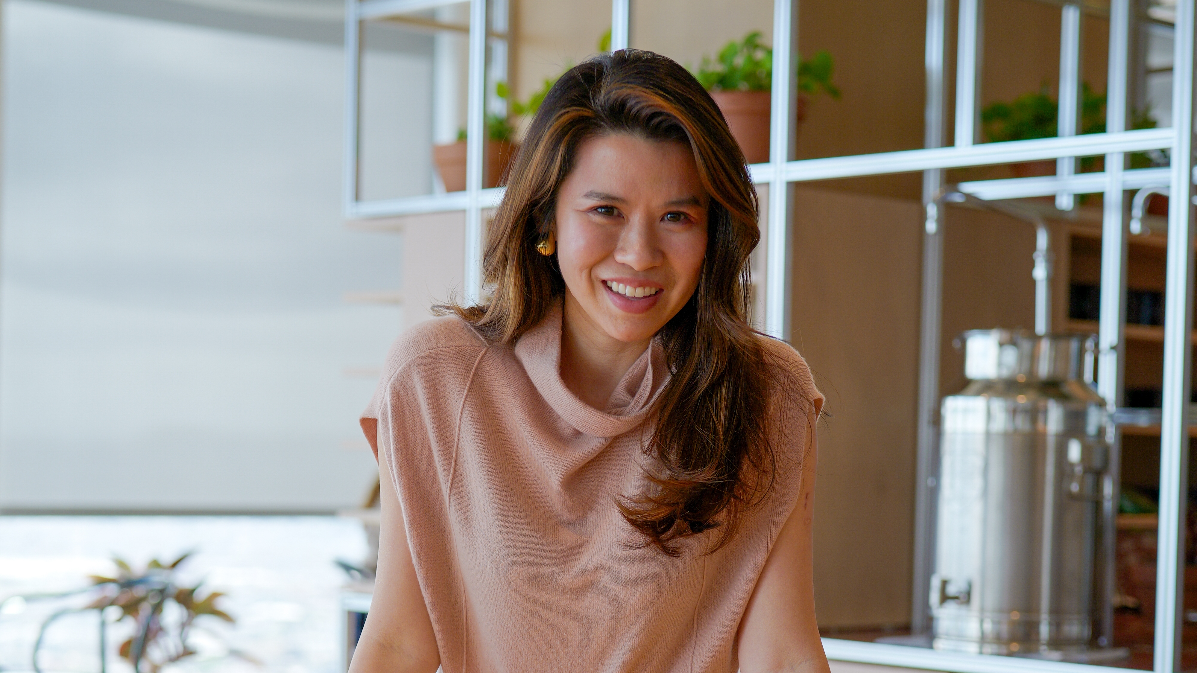 Jenny Shao seated in a bright room, smiling toward the camera