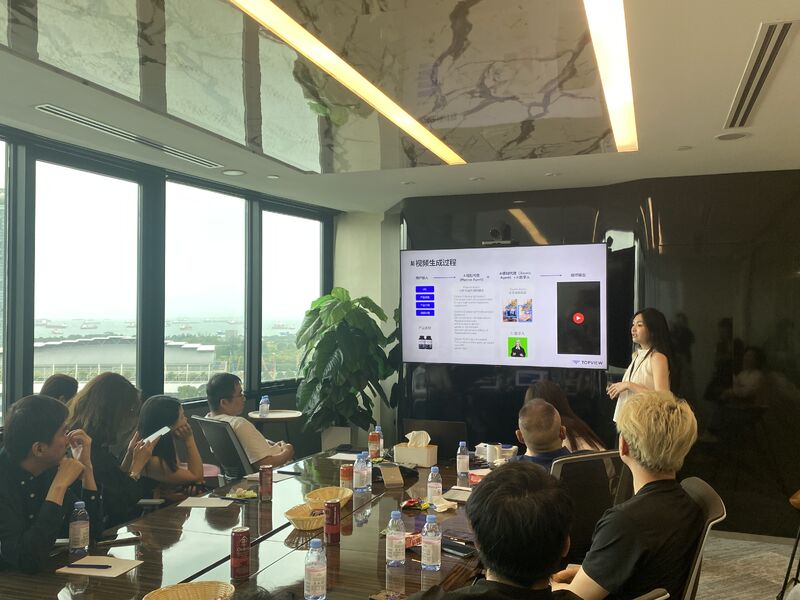 A Topview team presentation to a seated group, with video creation workflows on a screen