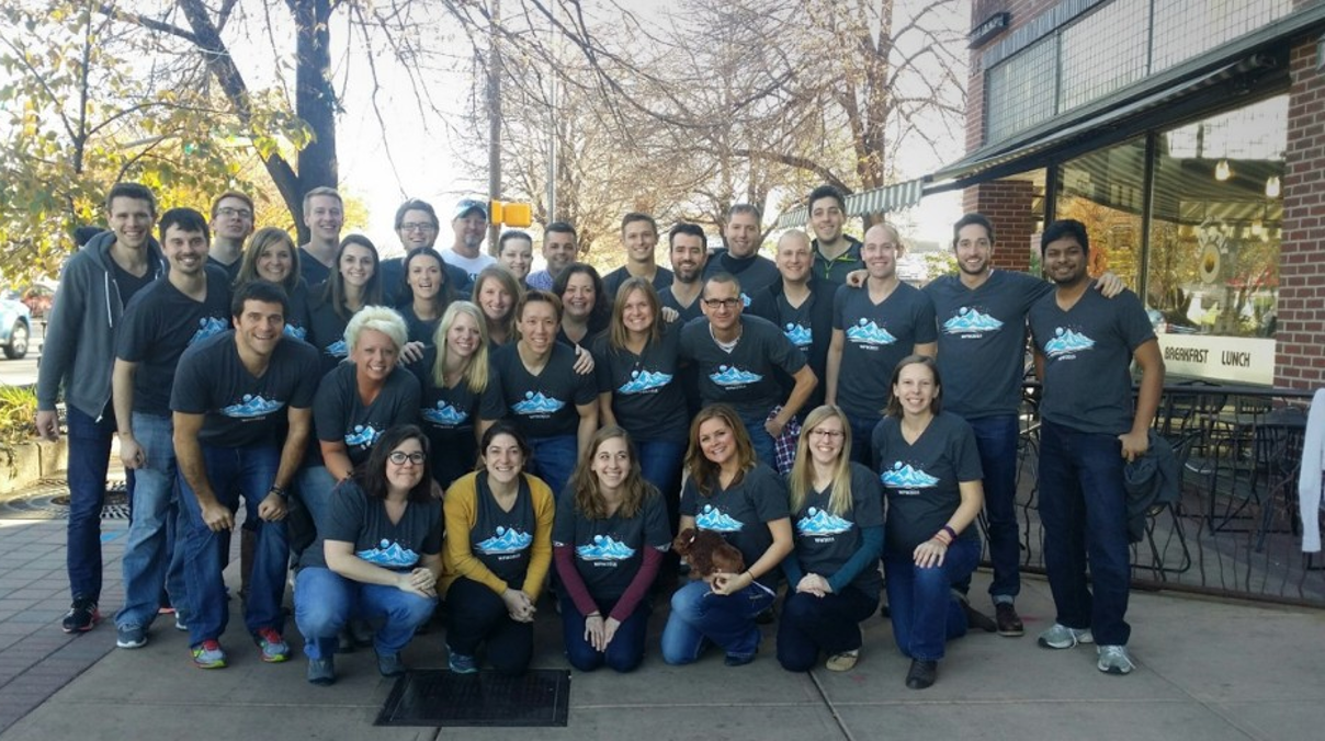 The Bluetree team gathered outdoors in matching blue shirts