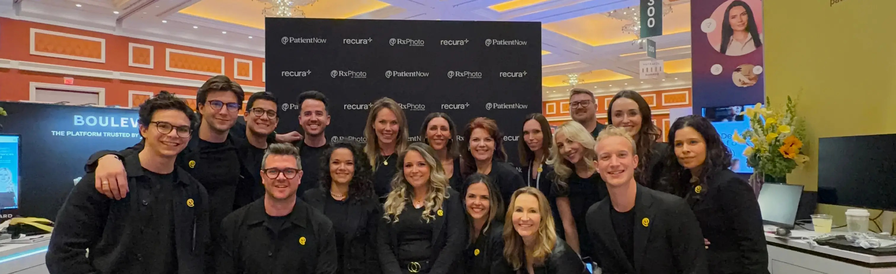 PatientNow team members gathered at a branded event booth