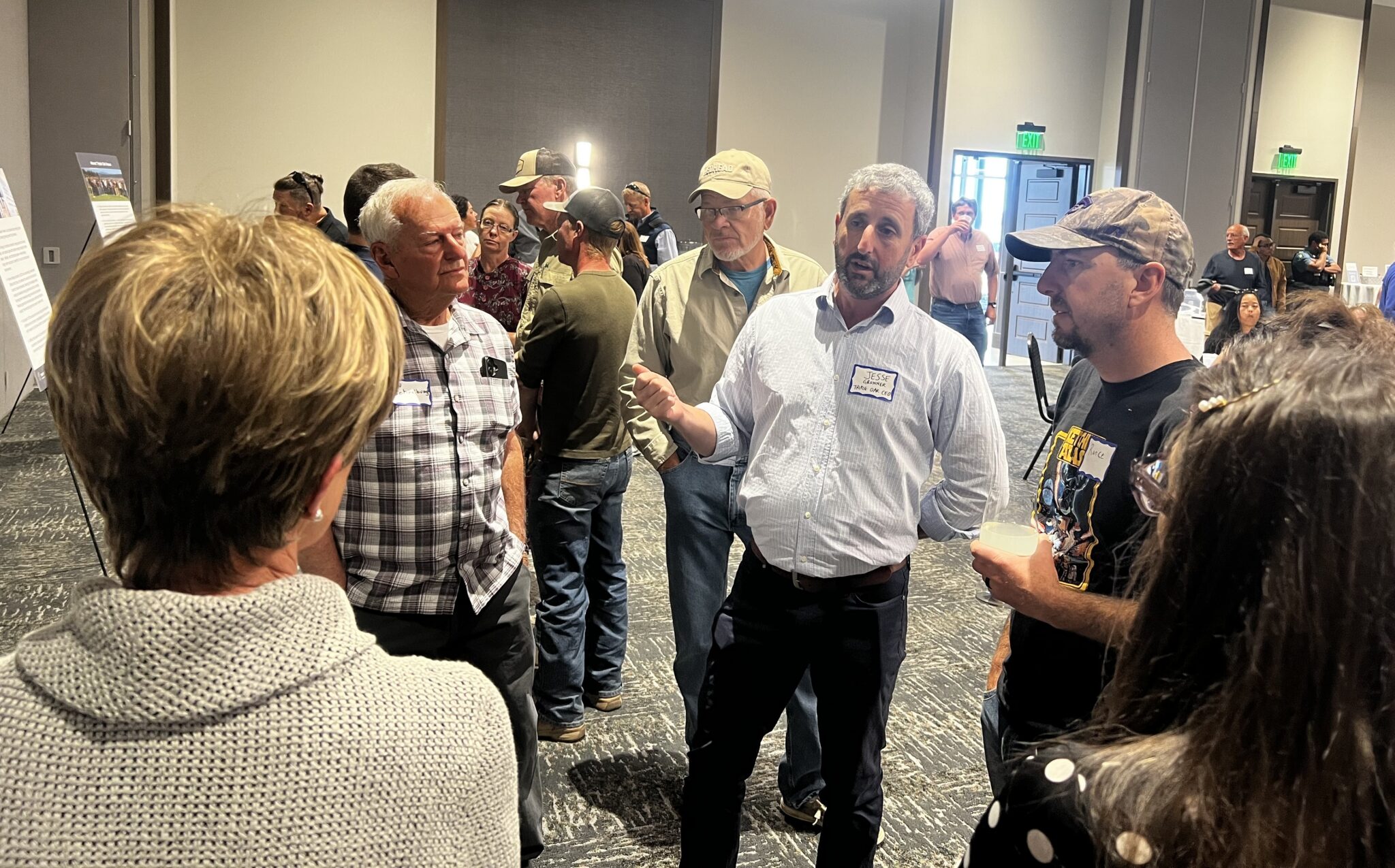 Jesse Gronner speaking with a group of residents at a Home Range Clean Power open house in Garden City, Kansas