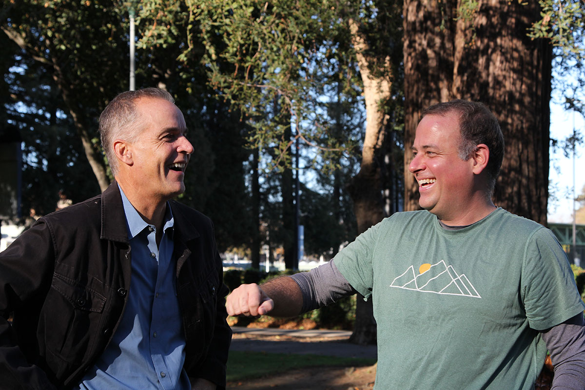 John Garner and Jesse Lindeman laughing together in Washington Park in Burlingame