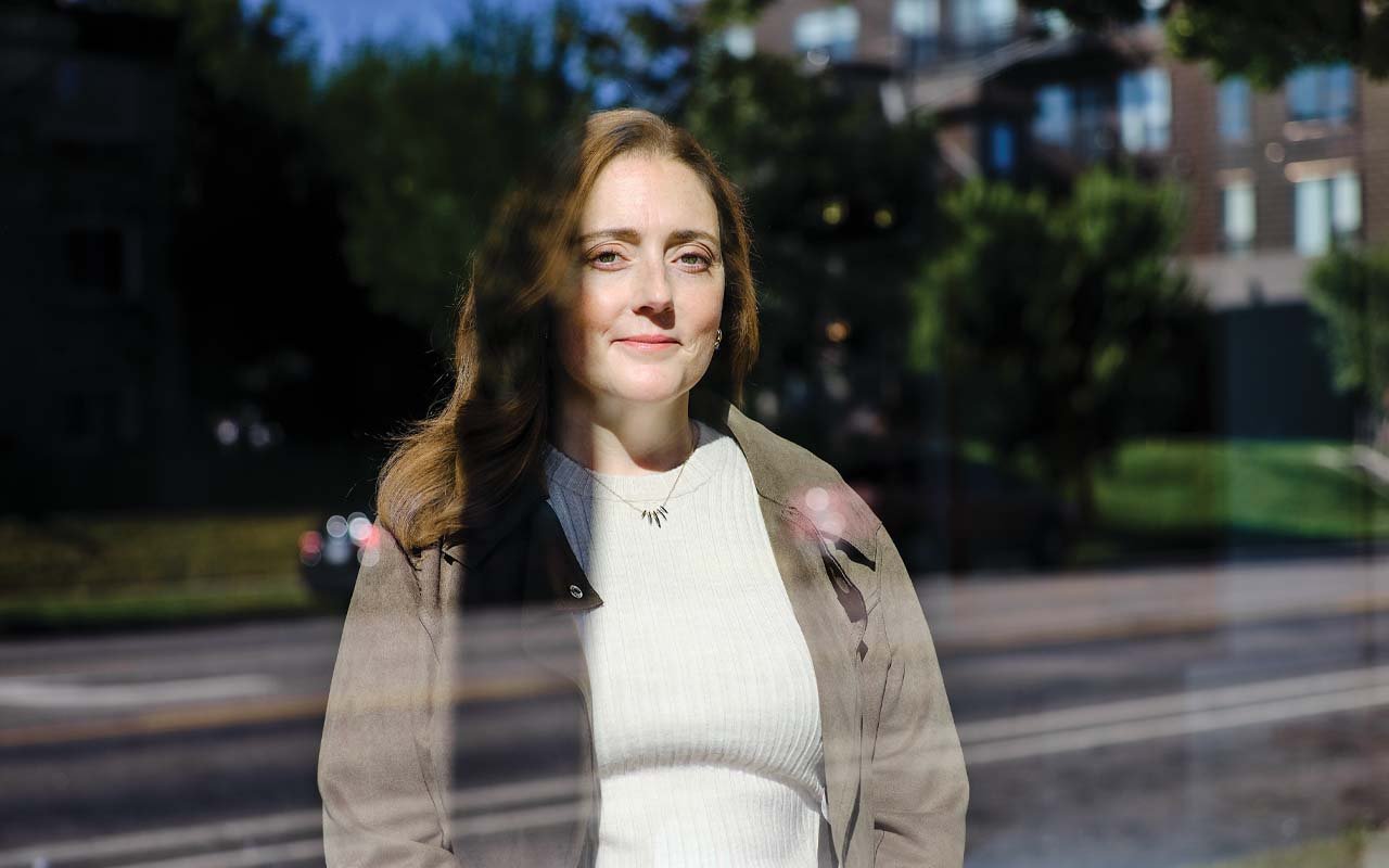 Jessica Cordova Kramer photographed through a window in Minneapolis