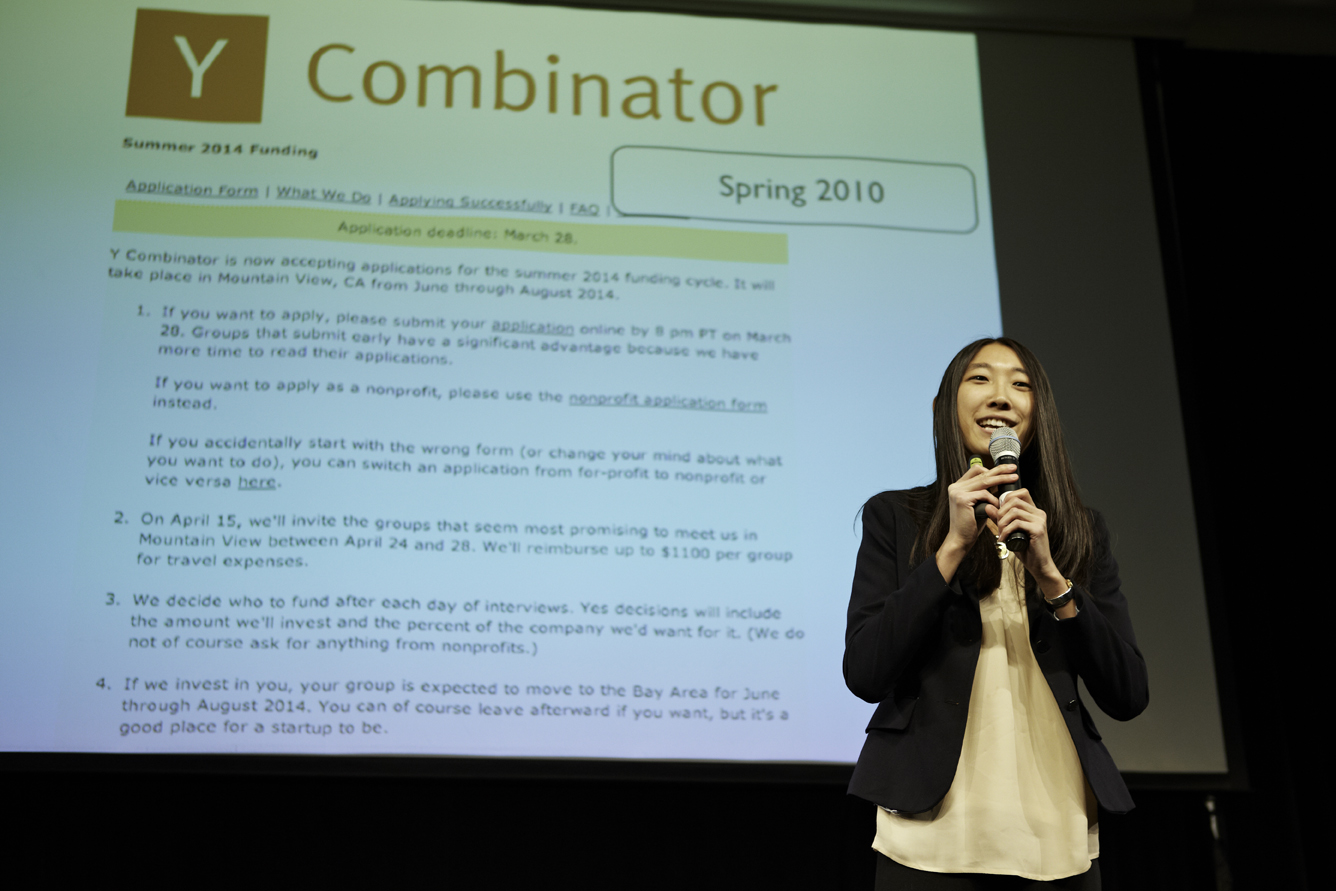 Jessica Mah speaking into a microphone in front of a projected Y Combinator application page