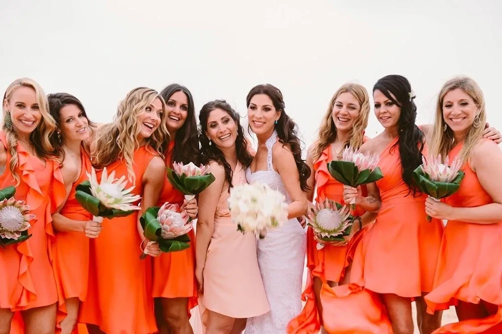 Jessica Meisels, in her wedding dress, surrounded by her wedding party in Maui