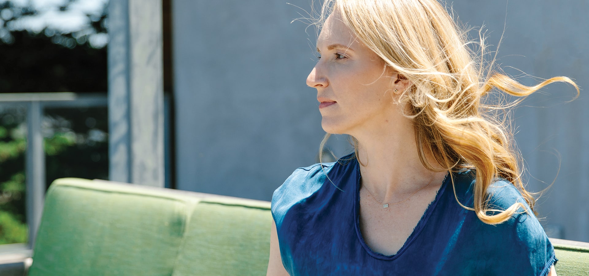 Jessica Powell seated outdoors, photographed in profile