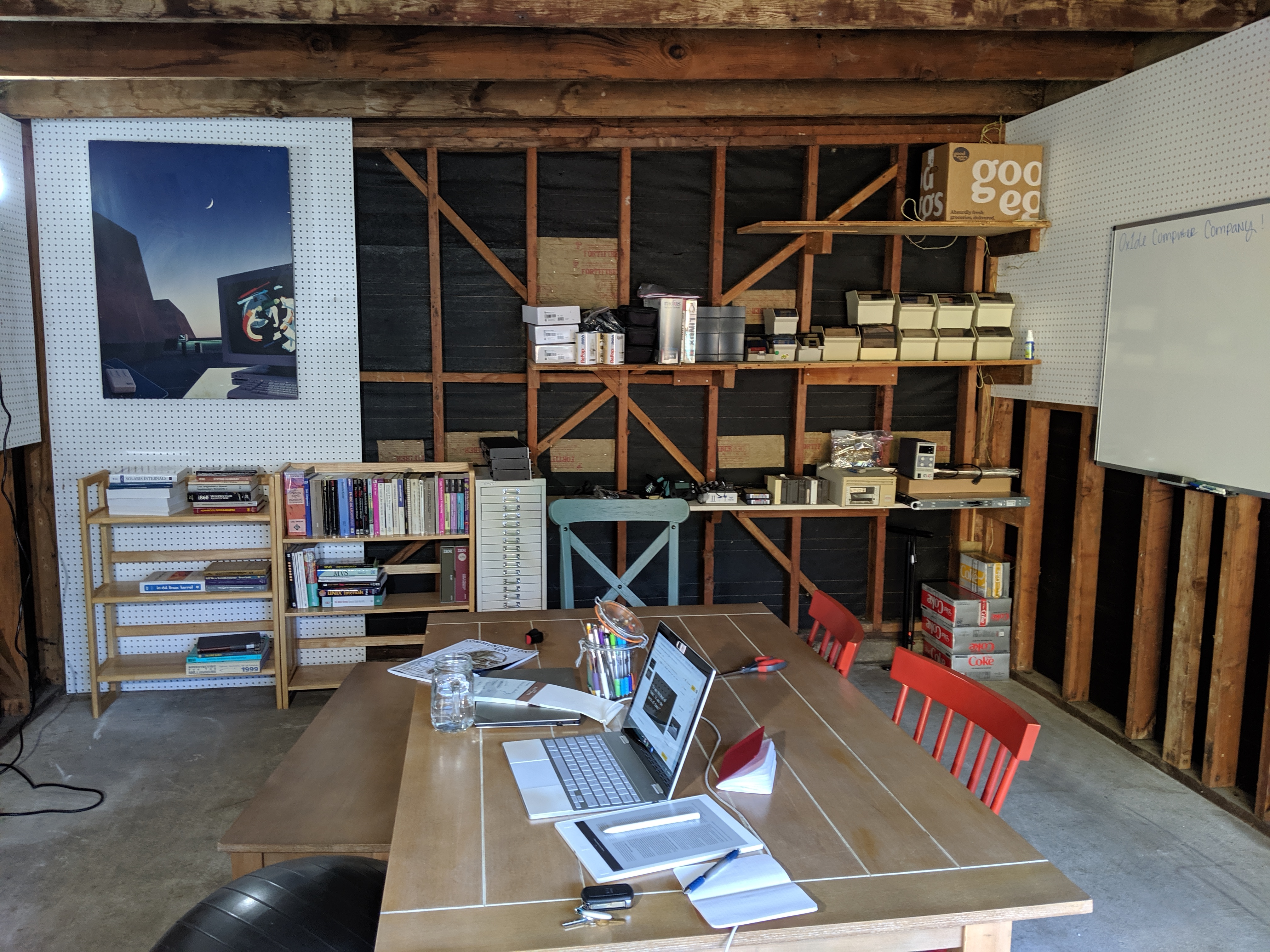 The garage used in Oxide’s early days, with computer manuals, equipment and a shared work table