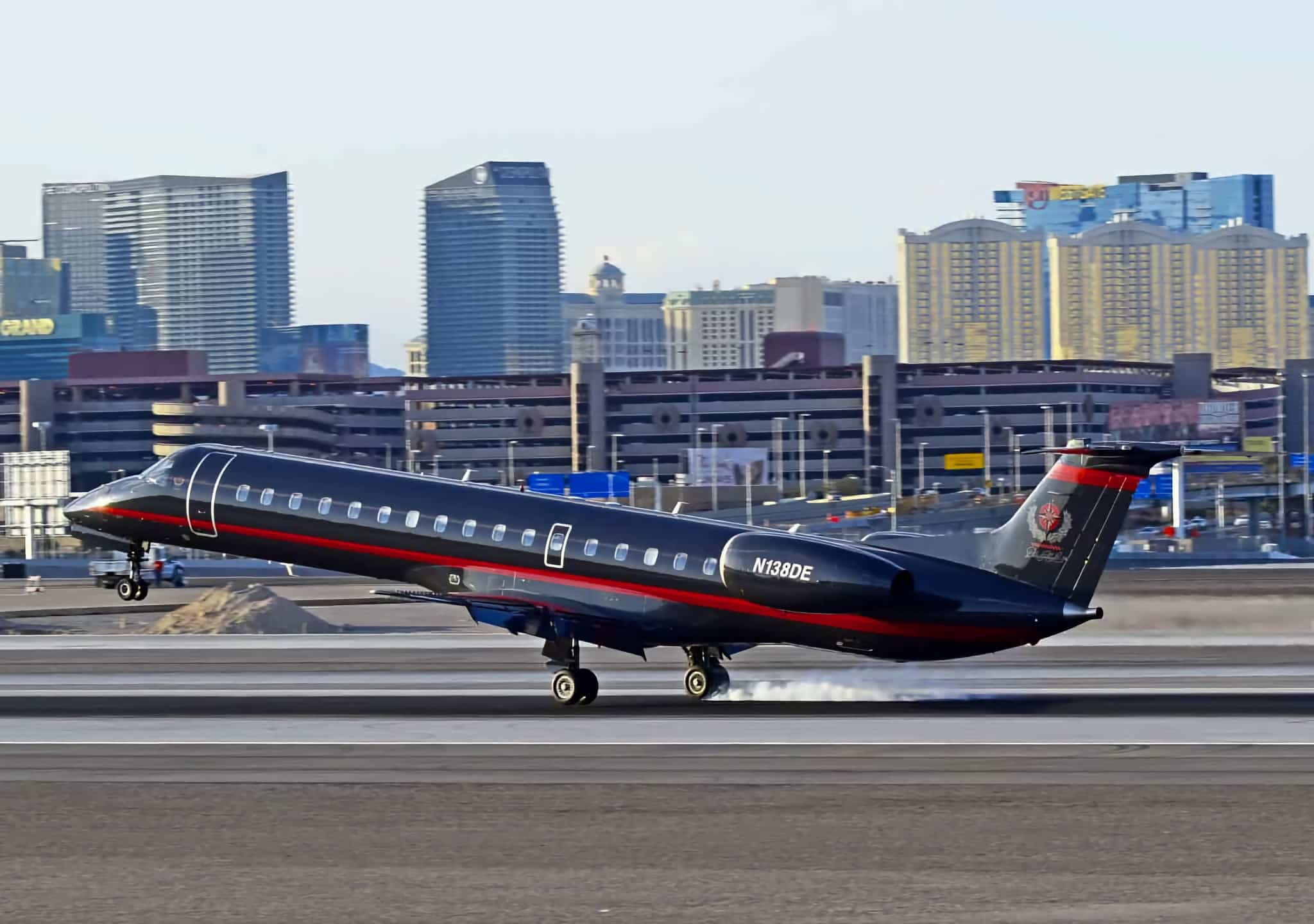 Champion Air Embraer aircraft touching down with a brief puff of tire smoke