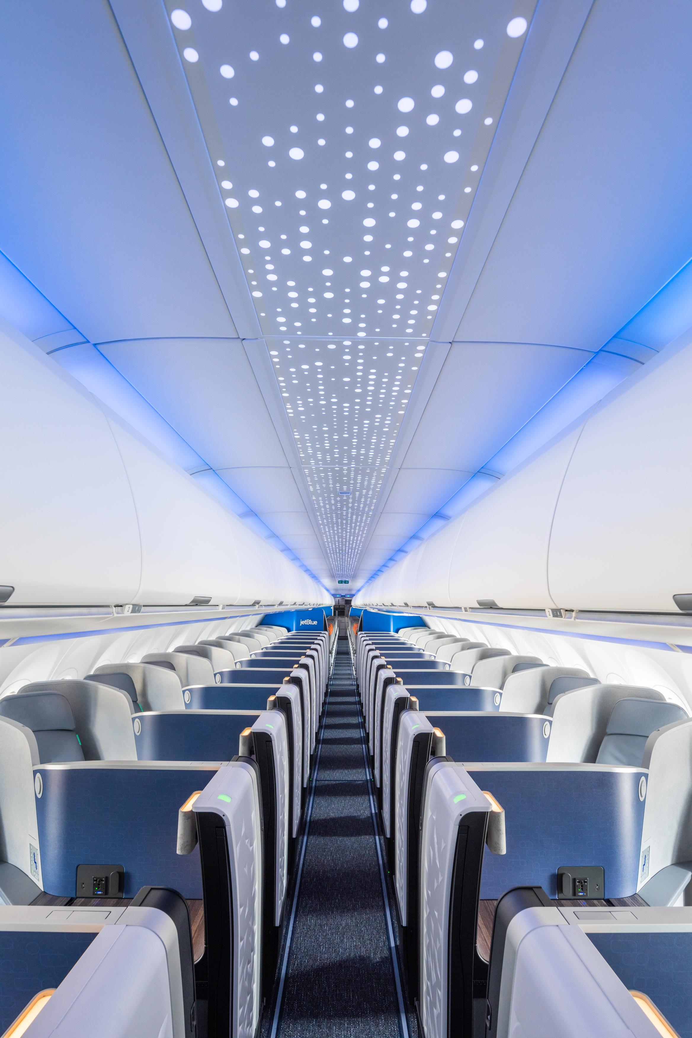 Illuminated ceiling and private seating in a JetBlue Mint cabin