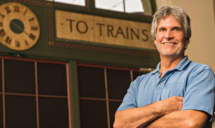 Jim Berlin inside Erie Union Station beside its historic To Trains sign