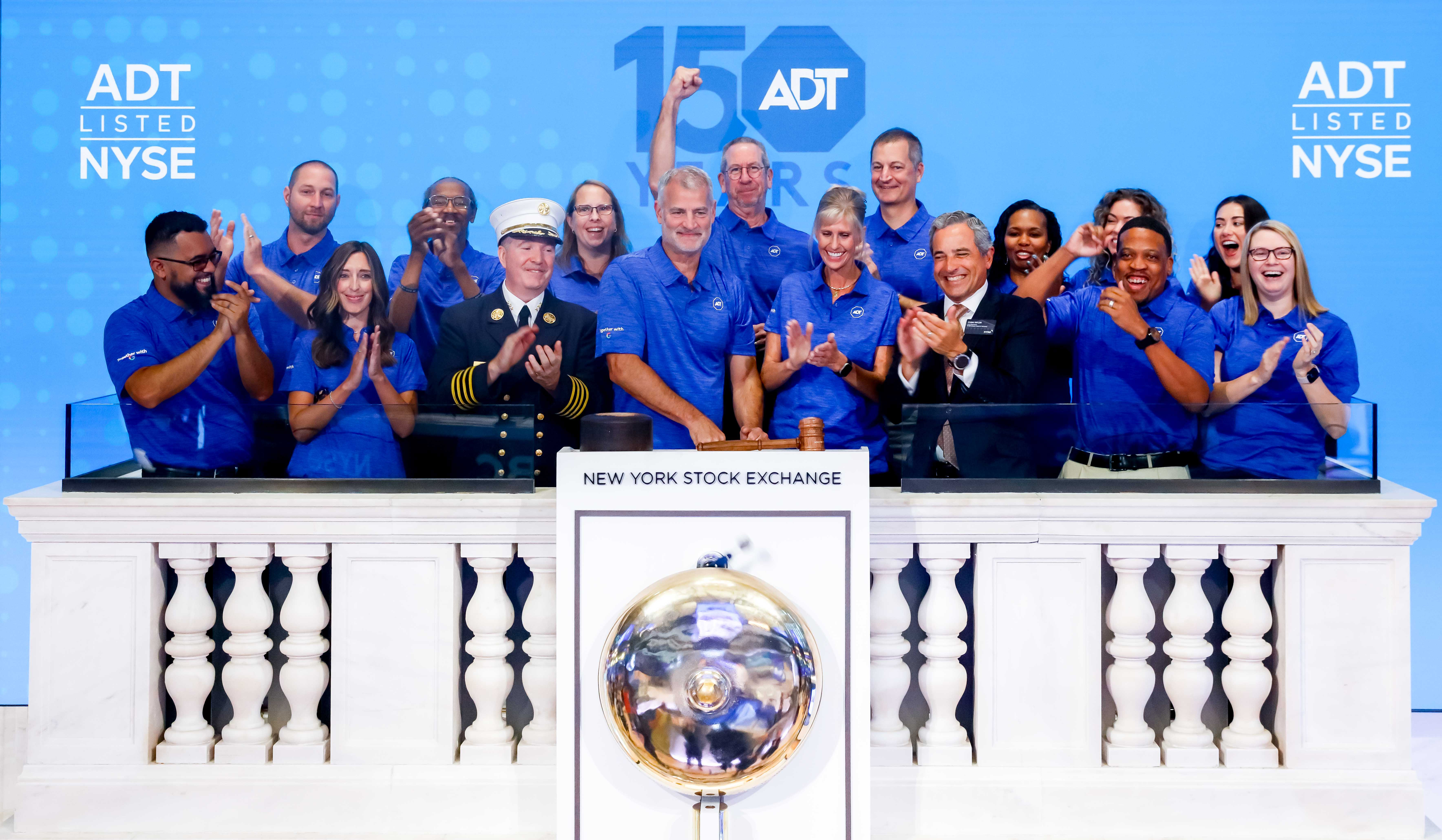 Jim DeVries and ADT employees celebrate at the New York Stock Exchange opening bell on August 13, 2024