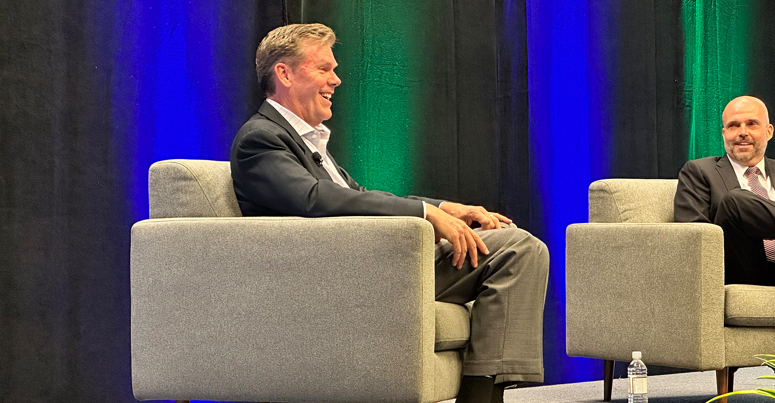 Jim Fish laughing during a seated discussion on the WasteExpo stage