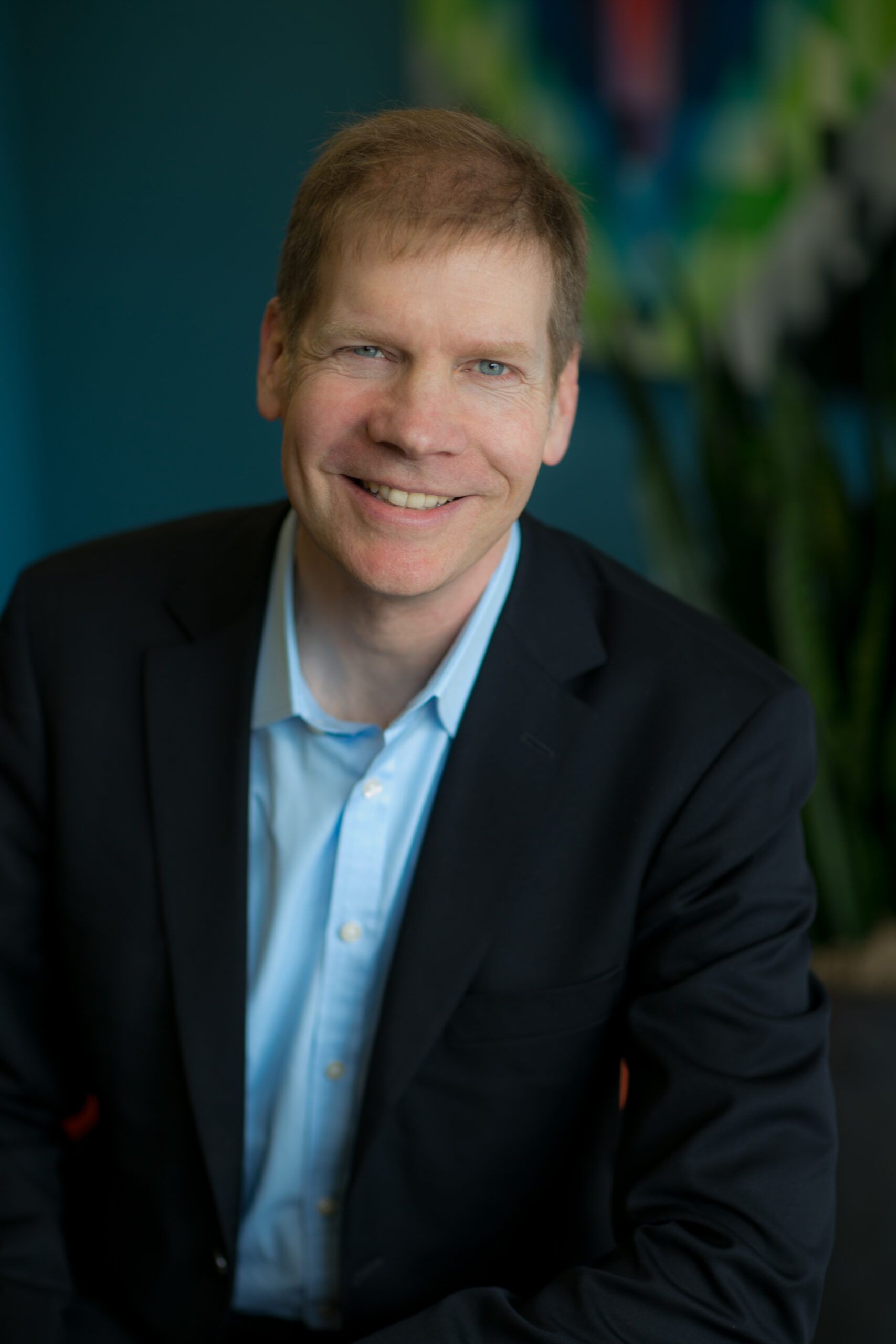 Jim Howard in a dark jacket and blue shirt, in a press portrait accompanying his Crownpeak interview