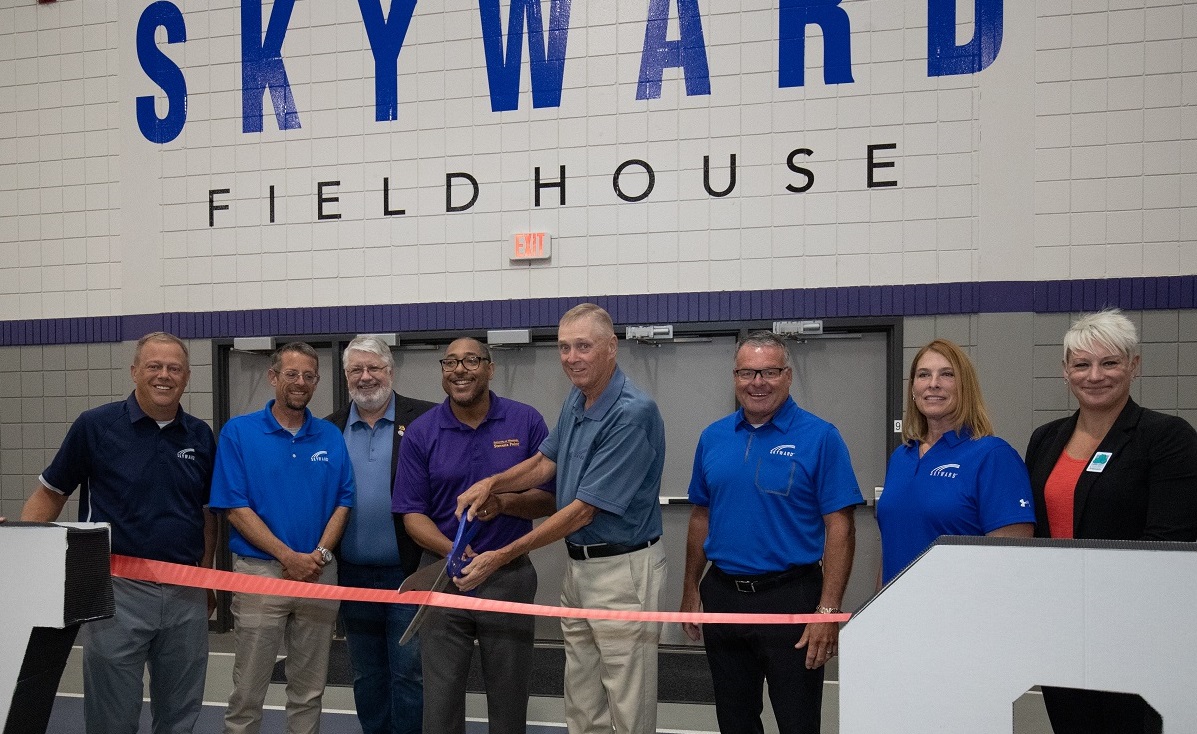 Jim King joins family, Skyward leaders and university representatives at the Skyward Fieldhouse ribbon cutting