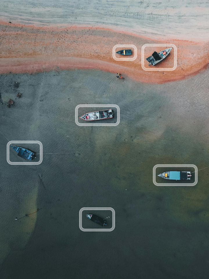 Striveworks website illustration showing detection boxes around boats viewed from above