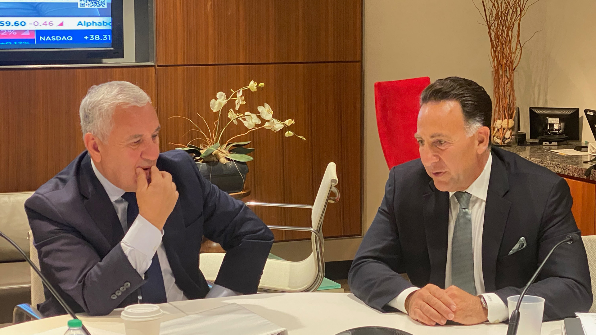 Jim Vena, left, and Norfolk Southern CEO Mark George seated at a table during a reporter conference call