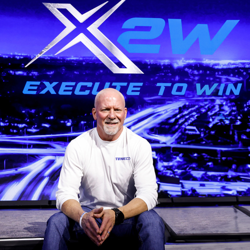 Jim Voss seated in front of an Execute to Win display