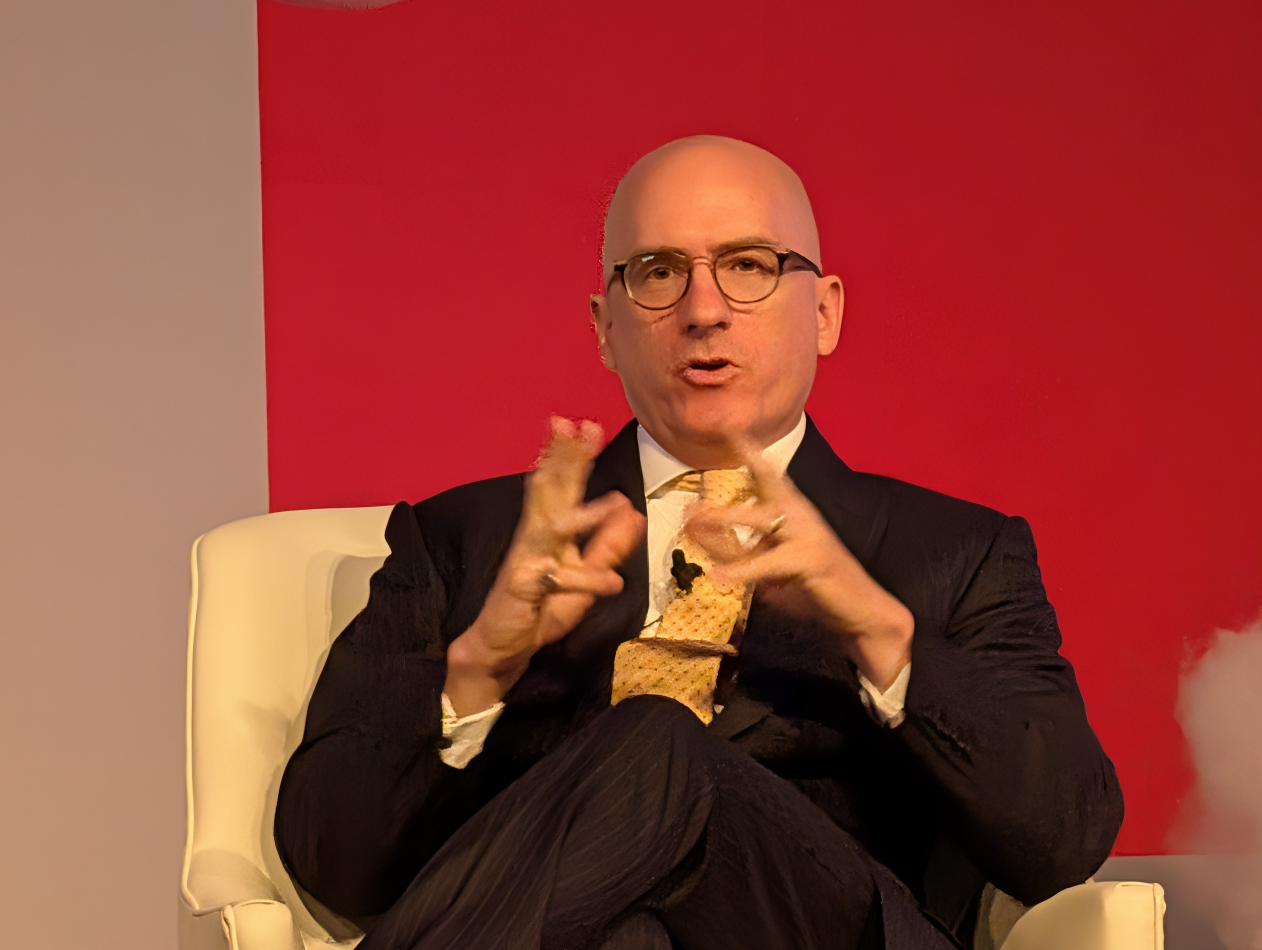 Jim Williamson speaking with animated hand gestures while seated at an S&P conference in 2026