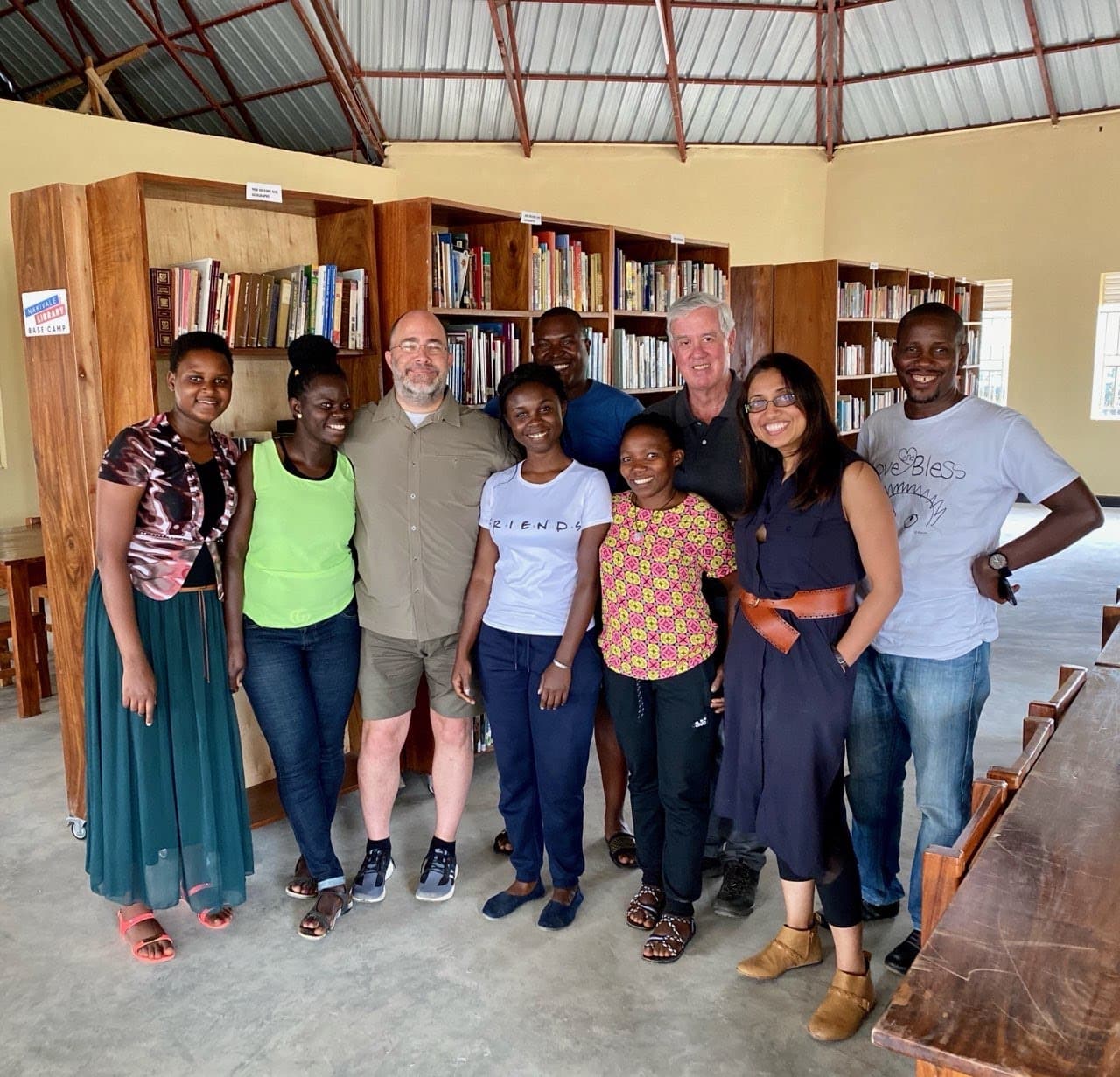 Jim Wolford standing with a group inside the library in Uganda
