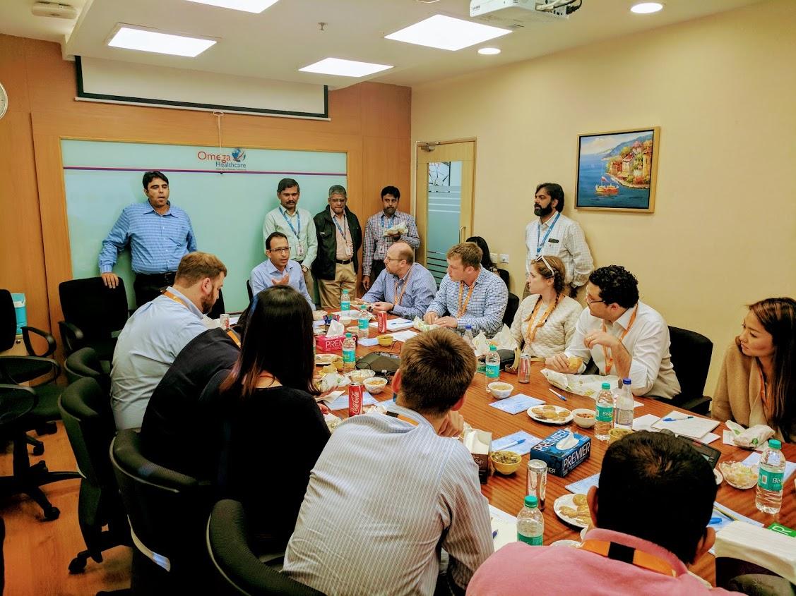 Jitendra Gupta speaking with visiting Darden students around a conference table in India