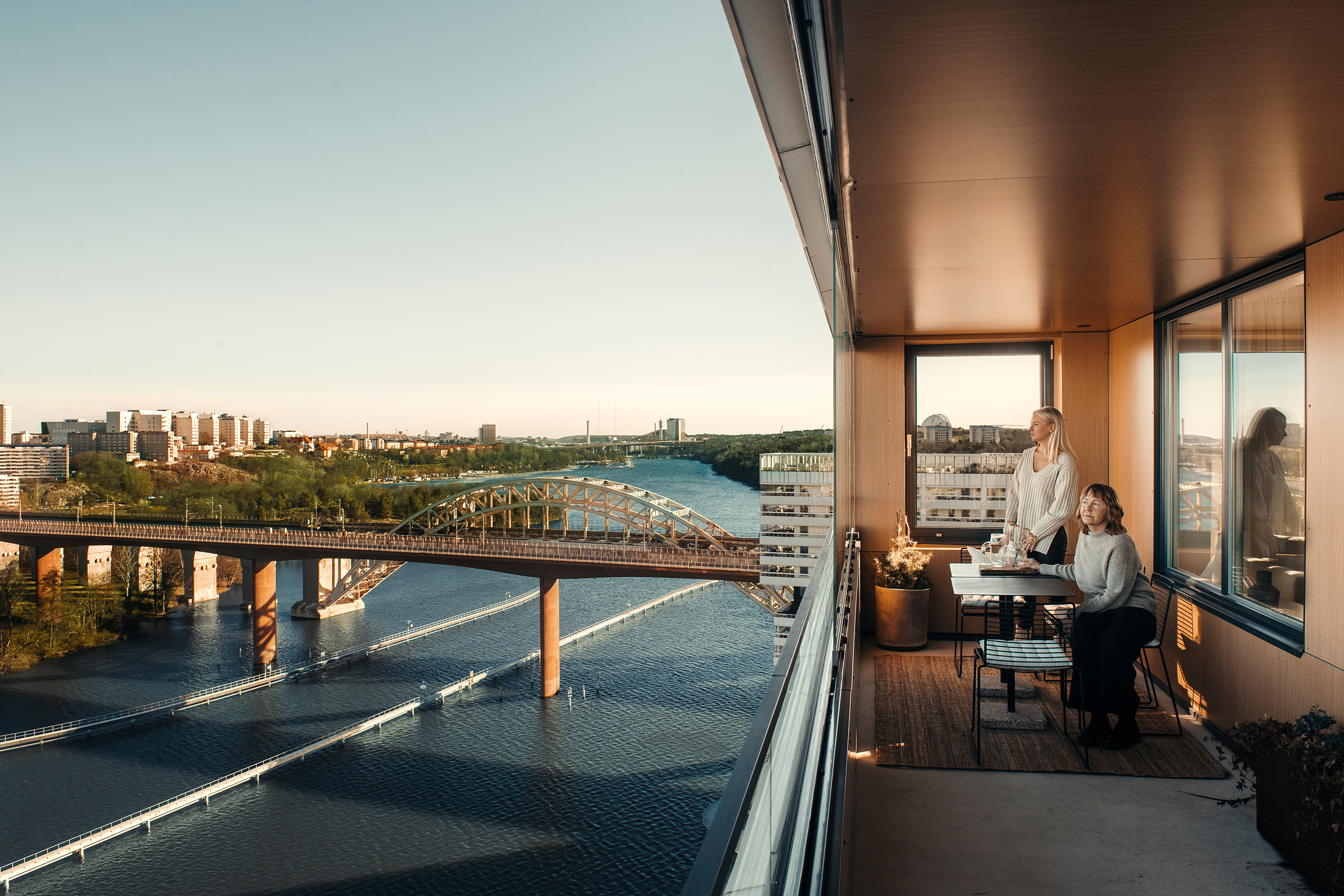 JM interior designers Emelie Waxin and Marie Ramse on a balcony overlooking Årstaviken in Stockholm