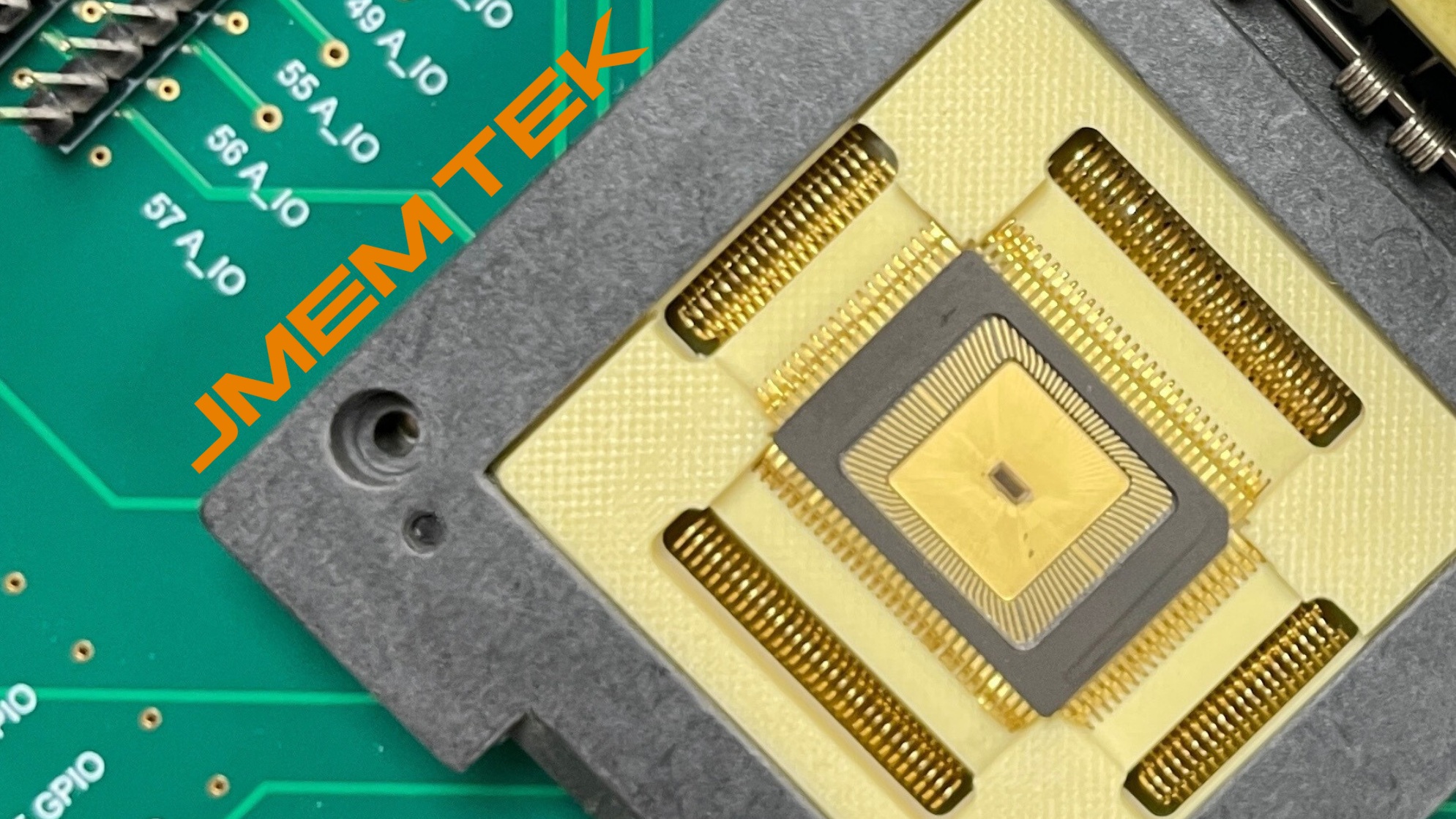 Jmem Tek product photograph showing a semiconductor die in a test socket on a circuit board