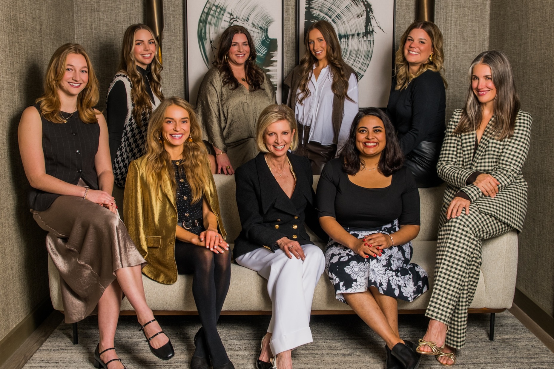 The all-women Jo Communications team seated and standing together in a designed interior