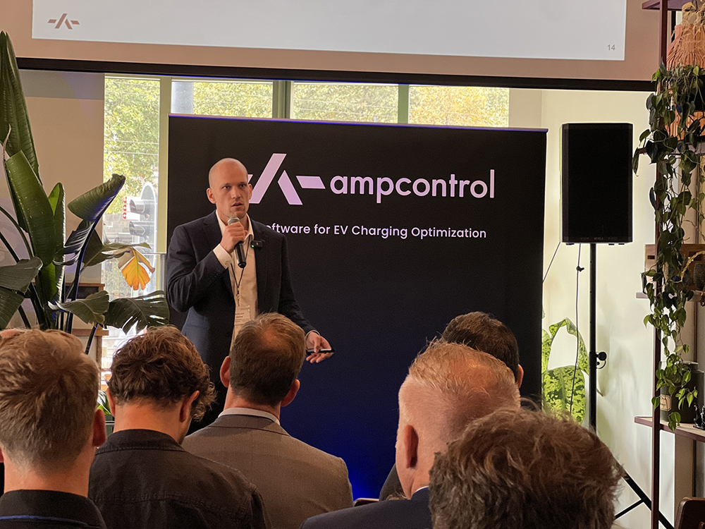 Joachim Lohse speaking into a microphone before an audience at the EV Fleet Summit in Rotterdam