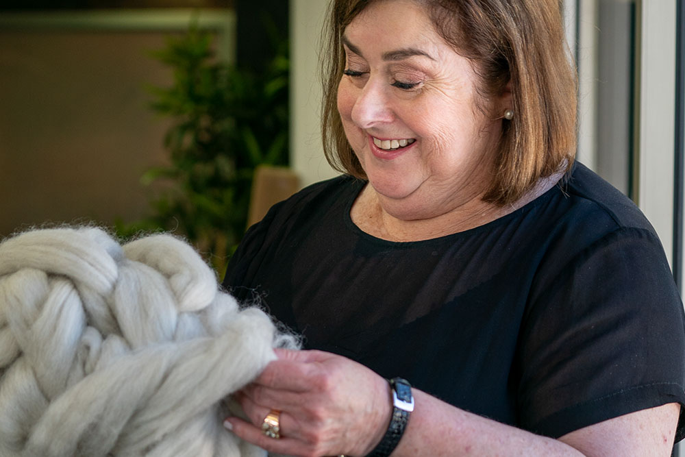 Joanne Howarth handling a bundle of wool fibres