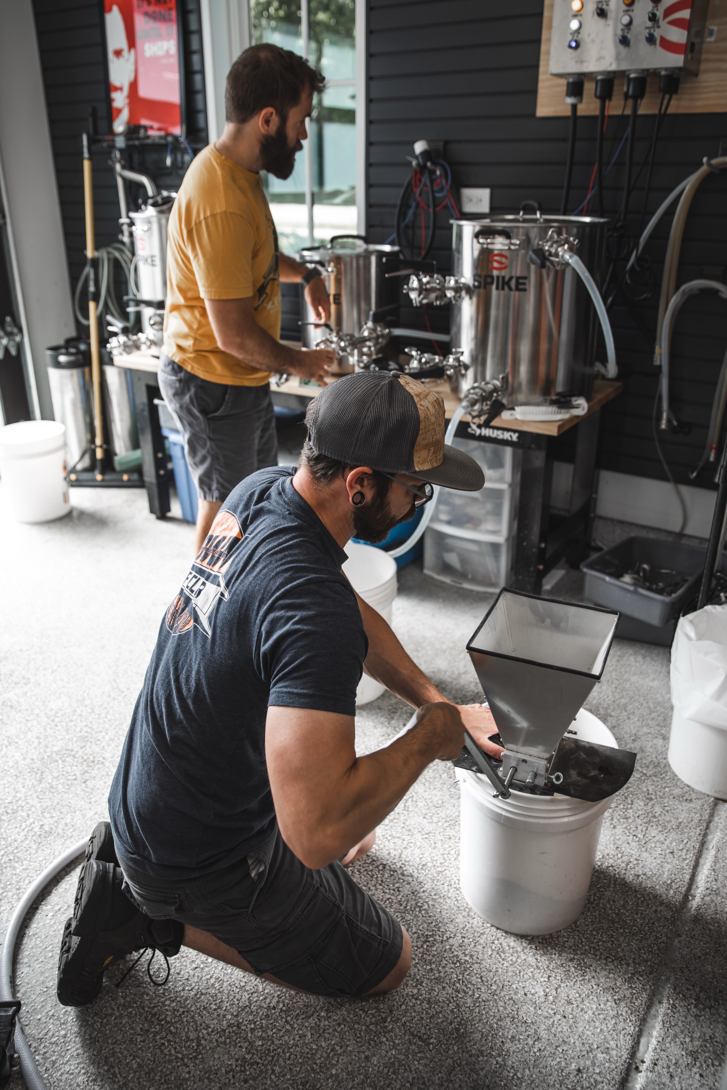 The early Go Brewing team working with brewing equipment in a garage