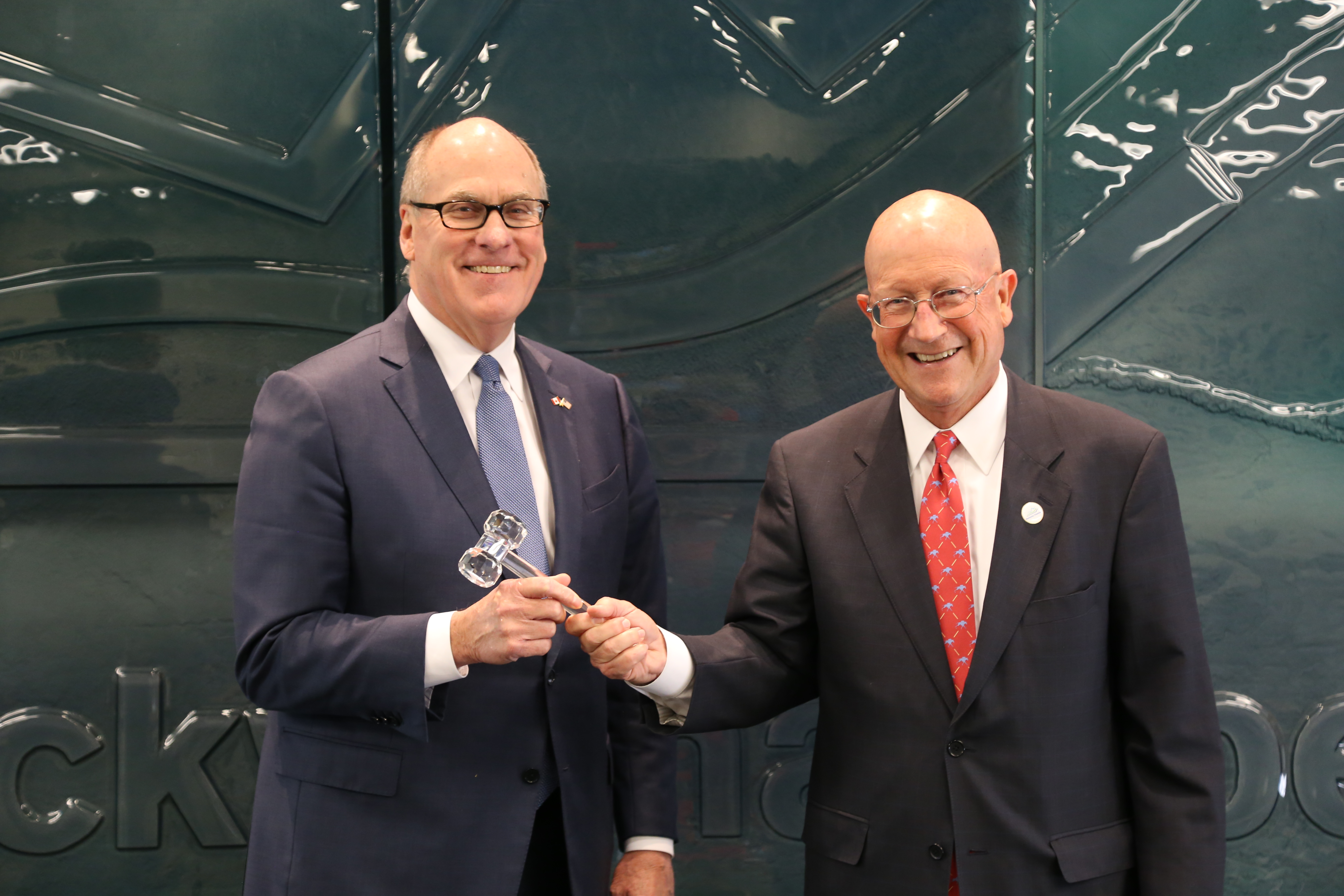 Joe Craft, left, and outgoing Kentucky Chamber chair Bill Lear holding a ceremonial gavel