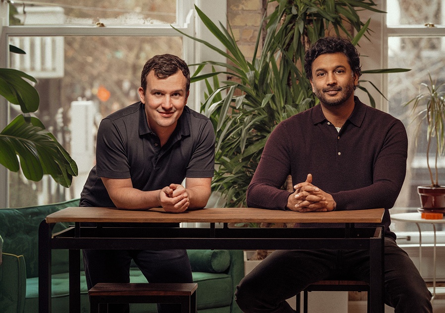 Joe Kelly, left, and Dhruv Bansal seated together at a table