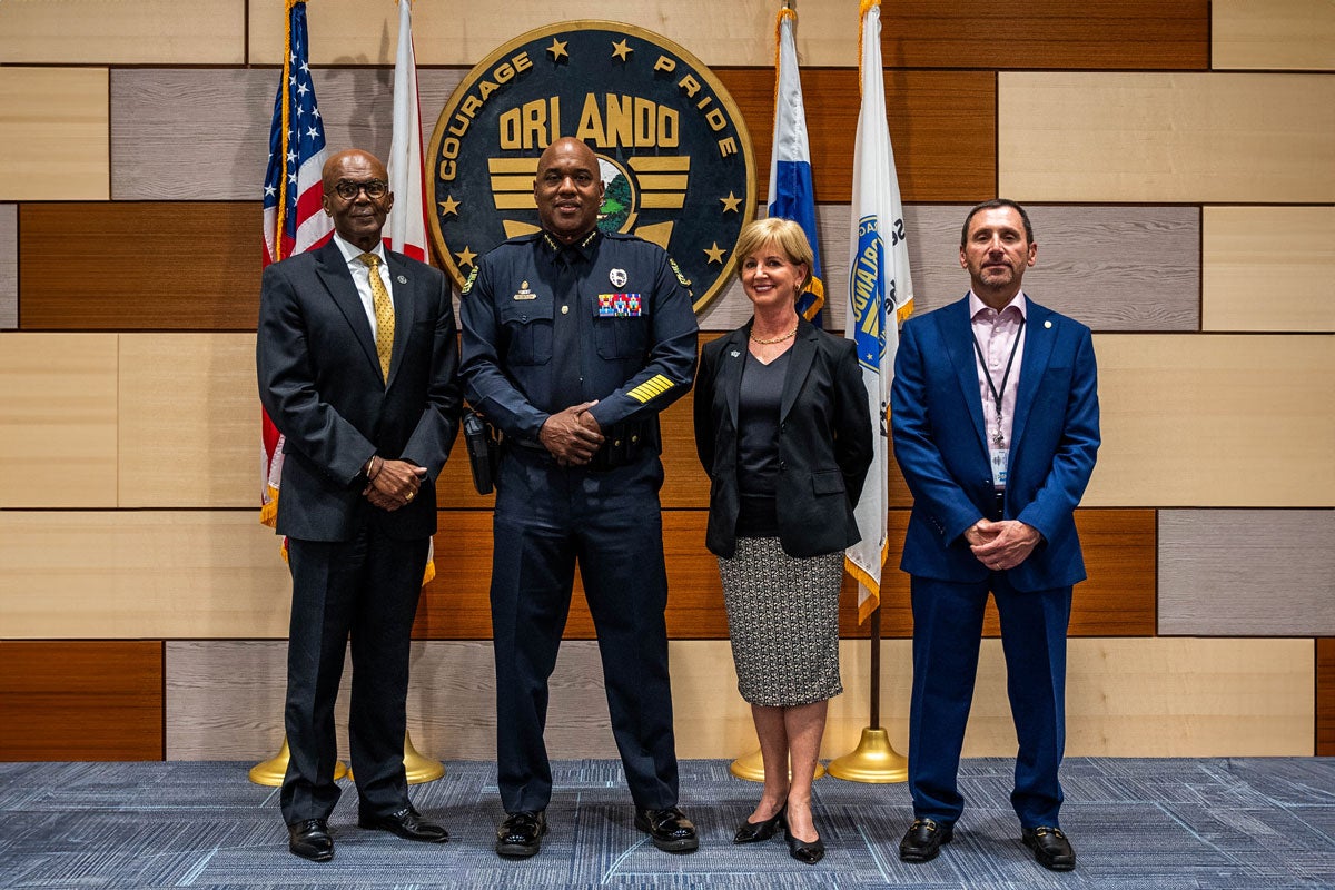 B. Grant Hayes, Orlando Police Chief Eric Smith, Roslyn Burrtram and Joe Nunziata at a UCF scholarship announcement