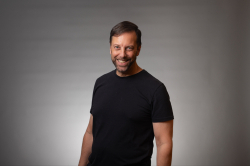 Joe Scotto in a black shirt against a gray studio background