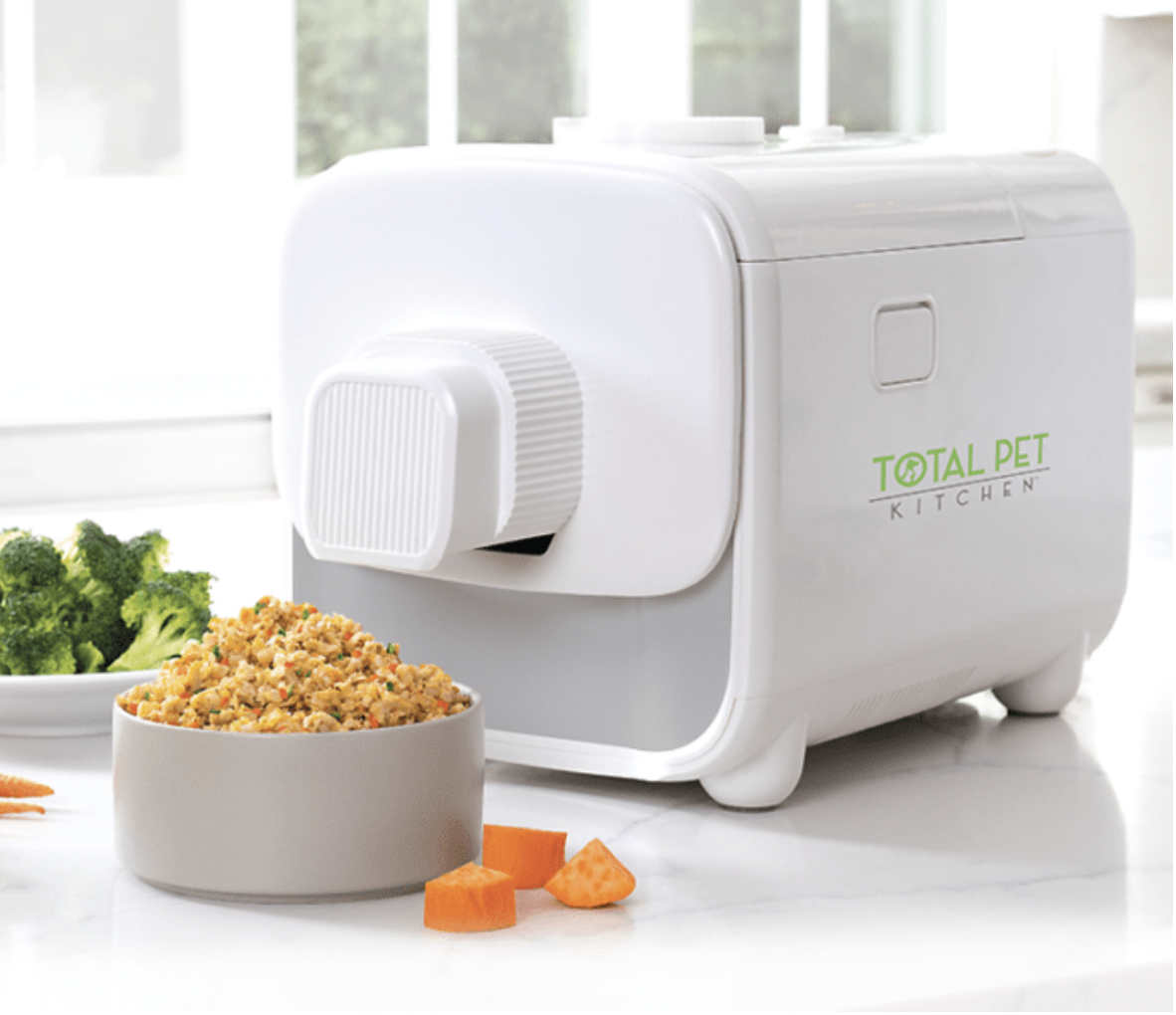 Total Pet Kitchen multi-cooker pictured beside a bowl of prepared pet food