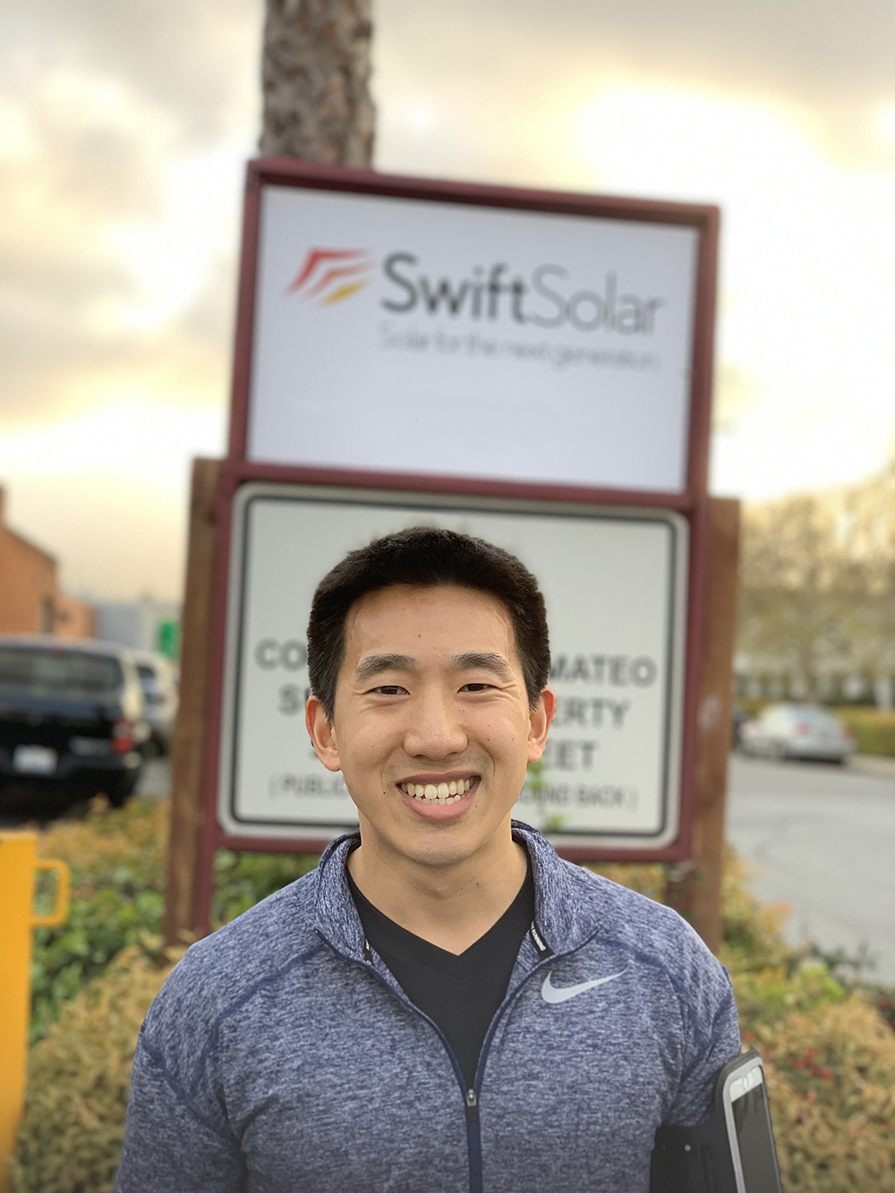Joel Jean, Co-Founder and CEO of Swift Solar, standing in front of the Swift Solar sign in San Carlos, California