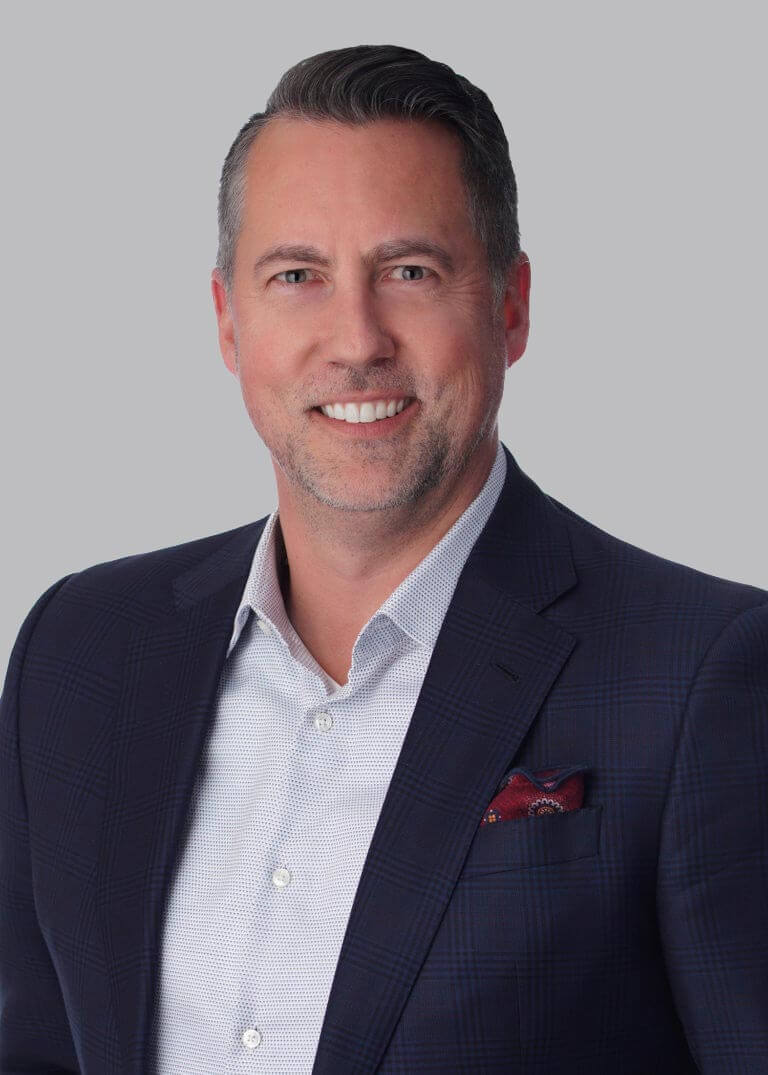 Joel Schaedler in a dark jacket against a neutral background