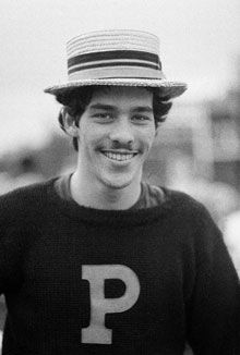 John Aristotle Phillips wearing a Princeton sweater and straw hat at a football game in 1976