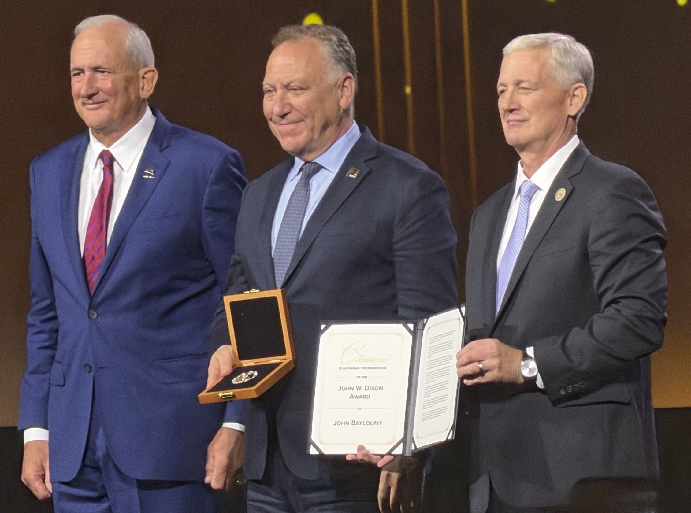 John Baylouny, center, holding his John W. Dixon Award with Robert Brown on the left and Jack Haley on the right.