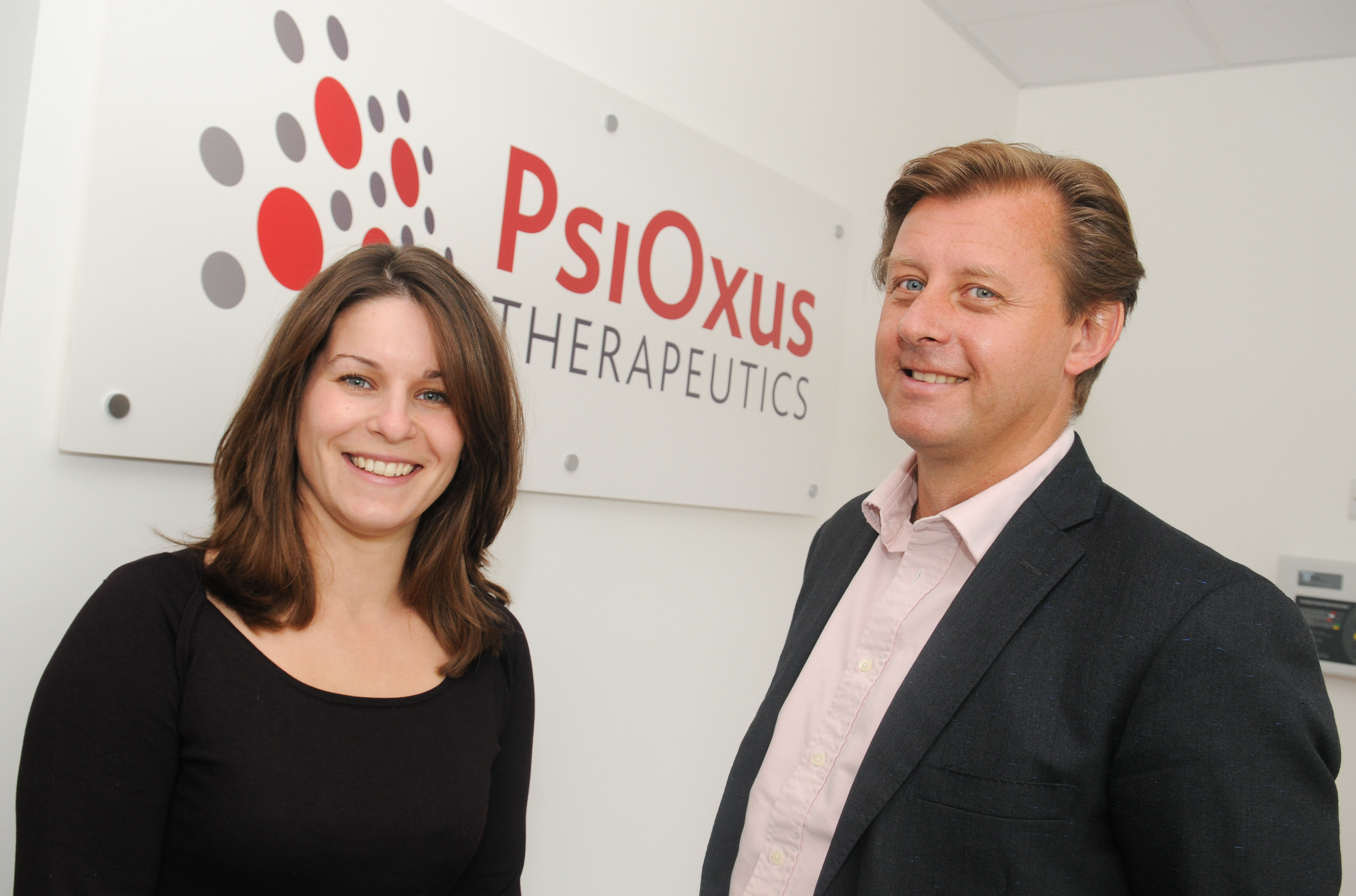 Jo Szegota, left, and John Beadle beside the PsiOxus sign at Milton Park in 2012.
