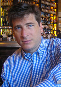 John Borthwick seated in a restaurant in an archival photograph