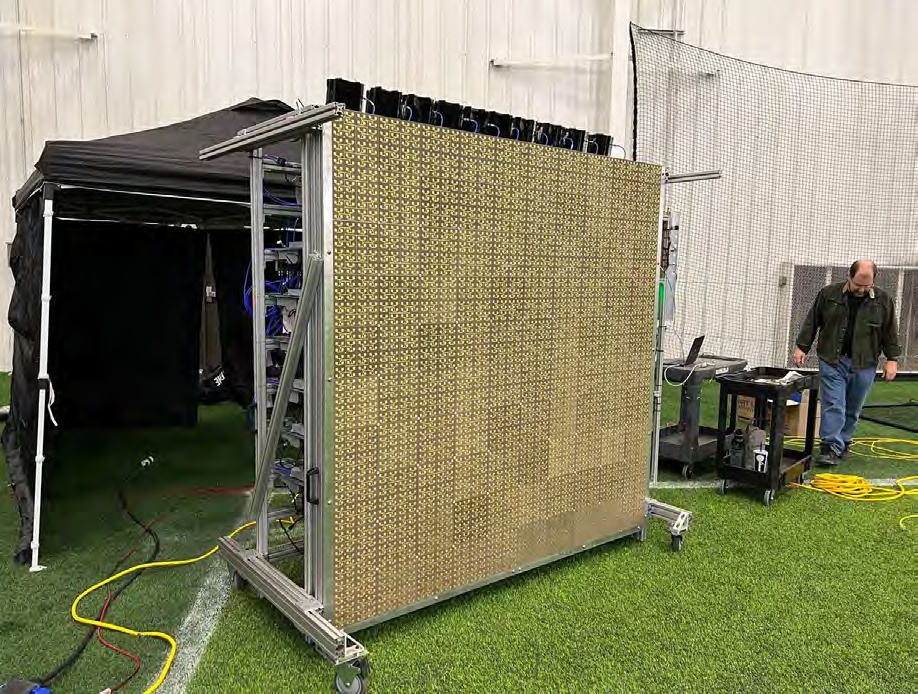 A large square phased-array transmitter on a wheeled frame at a Virtus Solis wireless-power test