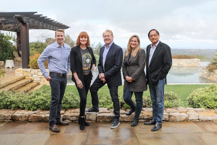 John Chambers stands at center with four members of the JC2 Ventures team outdoors.